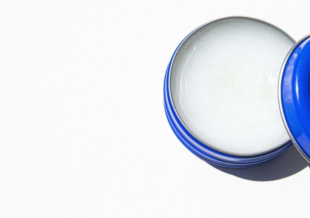 Petroleum jelly in a blue jar for skin moisture and healing.