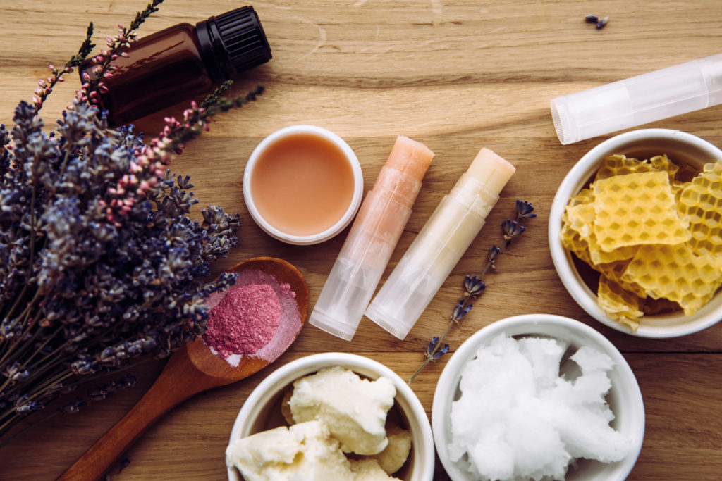 Ingredients for homemade lip balm: shea butter, essential oil, m