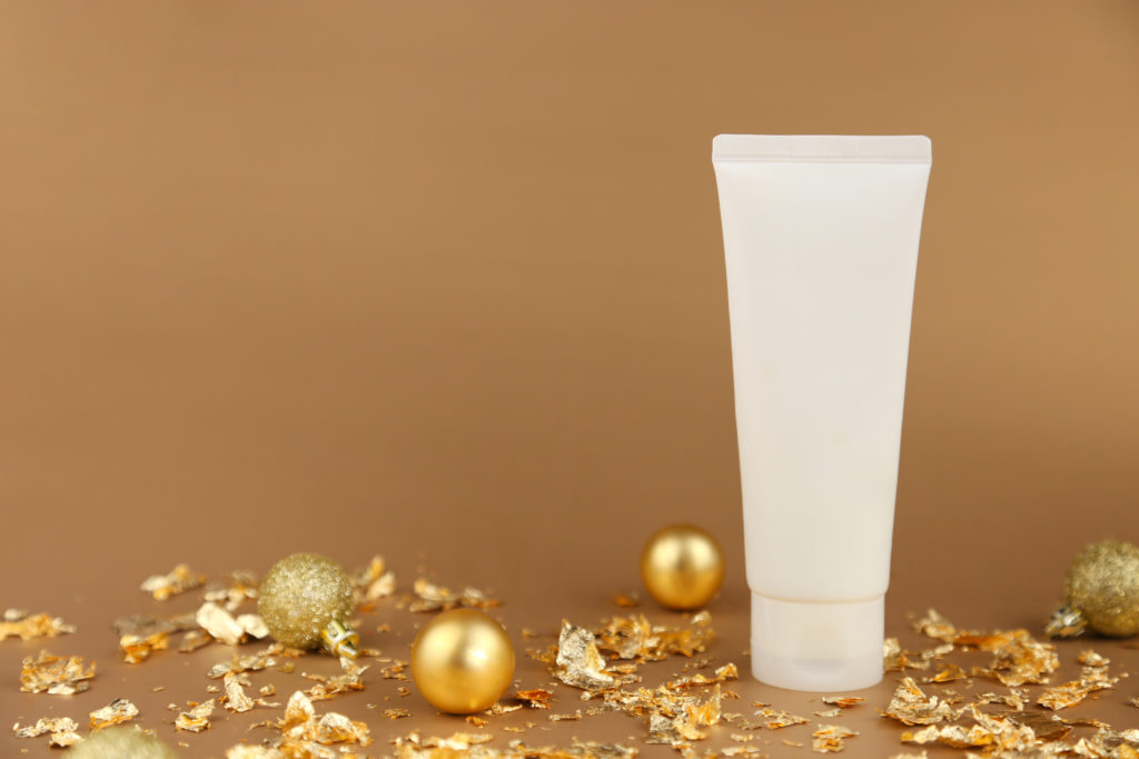 Unbranded face cream squeeze cosmetic tube, gold christmas balls